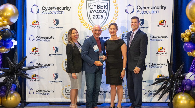 Dave Tohn of BTS Software Solutions receiving the Cybersecurity Award from Senator Katie Hester at the 2025 Cybersecurity Awards.