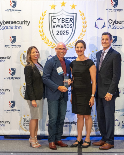 Dave Tohn of BTS Software Solutions receiving the Cybersecurity Award from Senator Katie Hester at the 2025 Cybersecurity Awards.